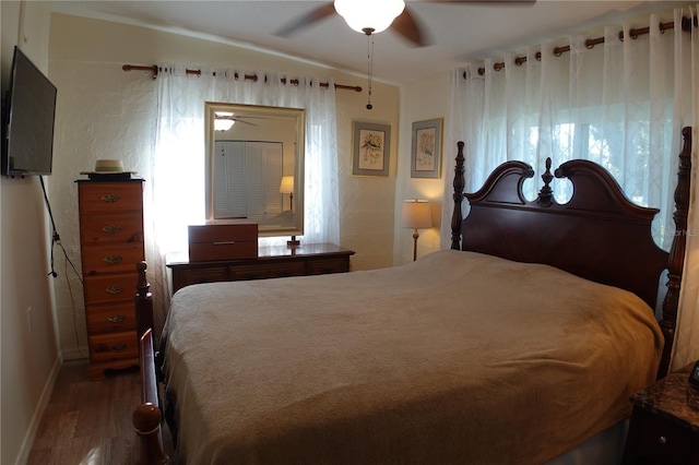 bedroom with wood finished floors, baseboards, and ceiling fan