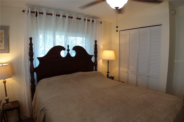 bedroom with a closet, ceiling fan, and vaulted ceiling