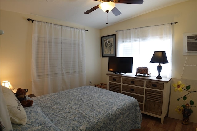 bedroom with lofted ceiling, wood finished floors, and a ceiling fan