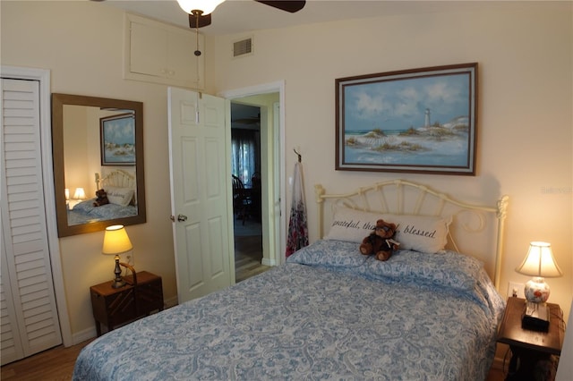 bedroom featuring wood finished floors, visible vents, and baseboards