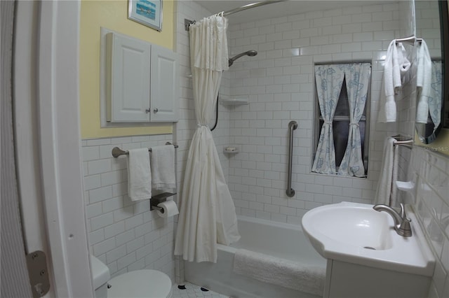 bathroom featuring a sink, toilet, tile walls, and shower / bath combo