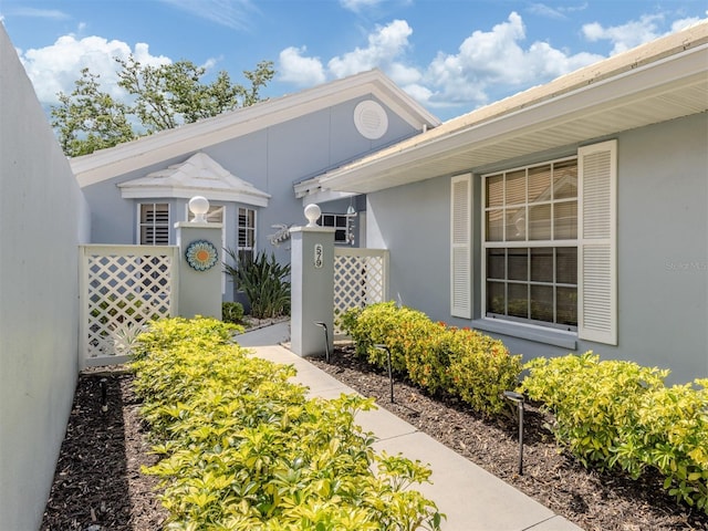 property entrance with stucco siding