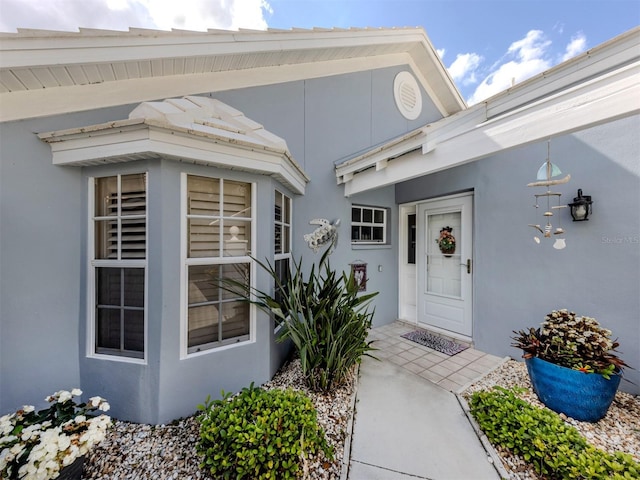 entrance to property with stucco siding