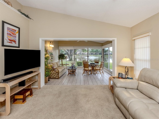 living area with carpet flooring, tile patterned flooring, and lofted ceiling