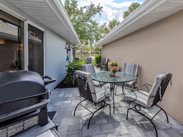 view of patio with a grill and outdoor dining area