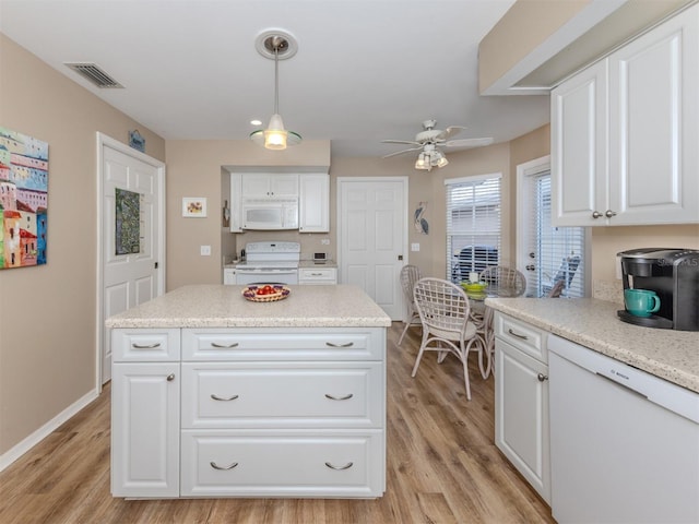 kitchen featuring light wood finished floors, white appliances, visible vents, and white cabinets