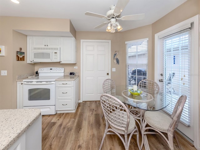 kitchen featuring white cabinetry, ceiling fan, light wood finished floors, and white appliances