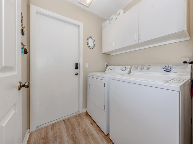 laundry area with independent washer and dryer, cabinet space, baseboards, and light wood-type flooring