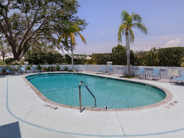 pool with fence and a patio area