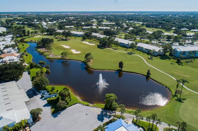 drone / aerial view featuring golf course view and a water view