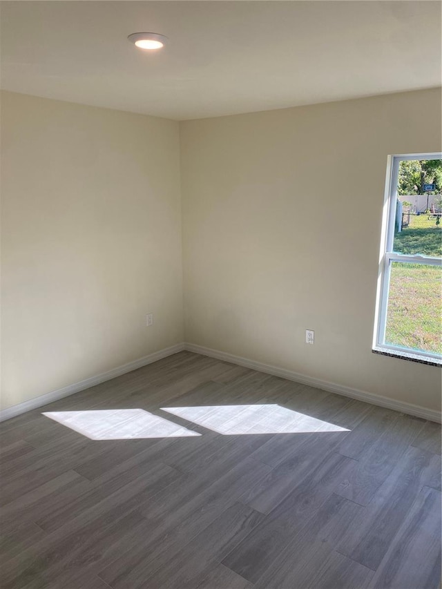 unfurnished room with recessed lighting, baseboards, and wood finished floors