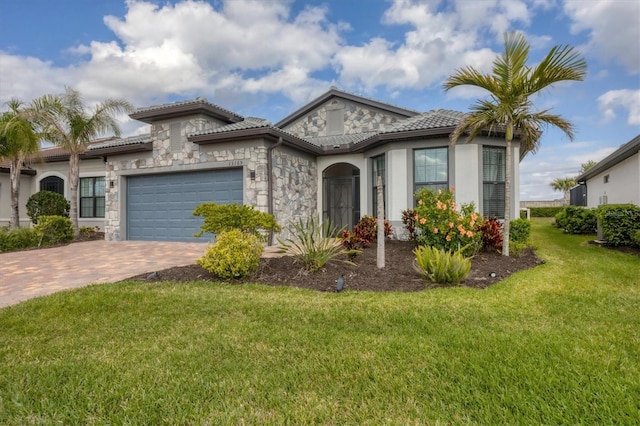 view of front of house with a front lawn, a tiled roof, a garage, stone siding, and driveway