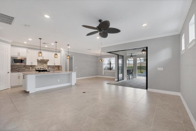 kitchen with visible vents, appliances with stainless steel finishes, crown molding, and ceiling fan