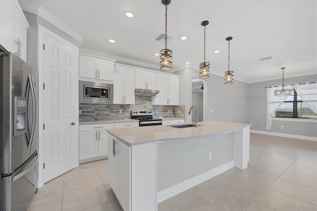 kitchen with visible vents, ornamental molding, a sink, under cabinet range hood, and stainless steel appliances