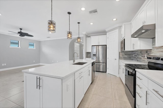 kitchen featuring tasteful backsplash, visible vents, under cabinet range hood, appliances with stainless steel finishes, and a sink