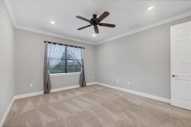 spare room with ceiling fan, ornamental molding, baseboards, and light carpet