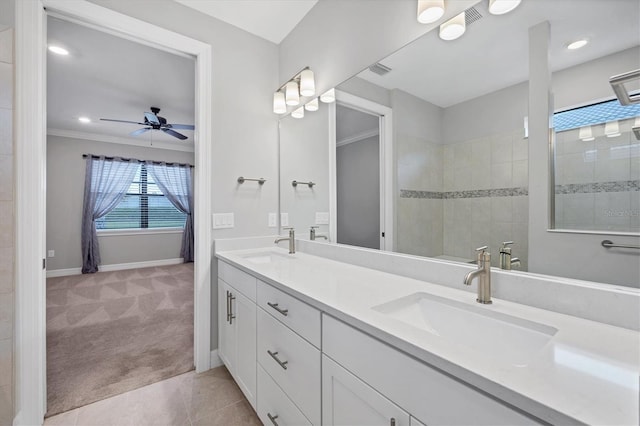 bathroom featuring a sink, double vanity, baseboards, walk in shower, and ceiling fan