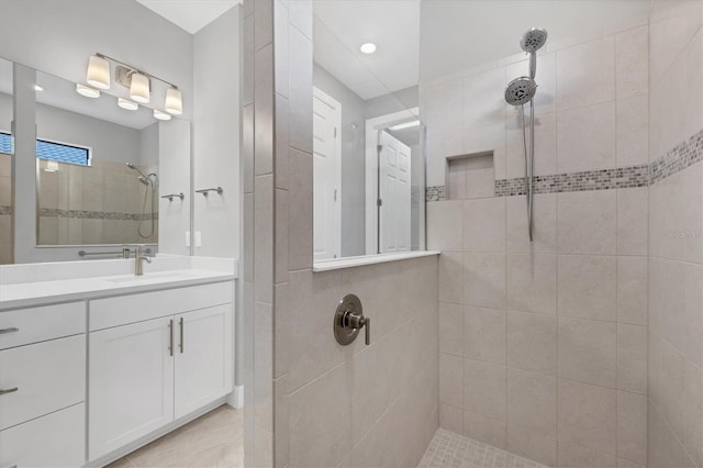 full bath with vanity and a tile shower