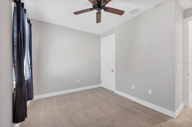 unfurnished room featuring carpet flooring, baseboards, visible vents, and ceiling fan