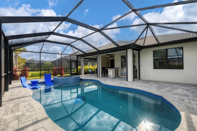 view of pool featuring a ceiling fan, a lanai, a patio area, and a pool with connected hot tub