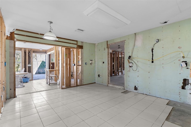 unfurnished room with light tile patterned floors and visible vents