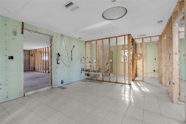 empty room with light tile patterned flooring and visible vents