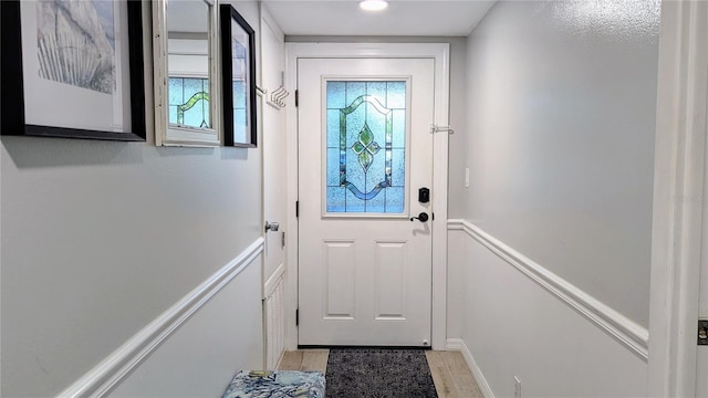 entryway with light wood-style floors and a wealth of natural light