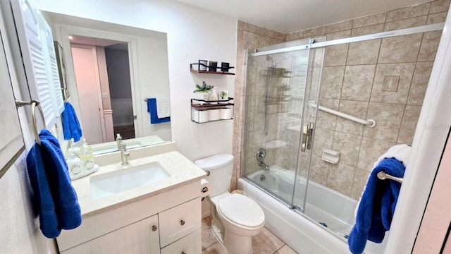 bathroom with vanity, toilet, and shower / bath combination with glass door