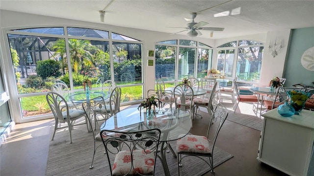 sunroom / solarium with a ceiling fan