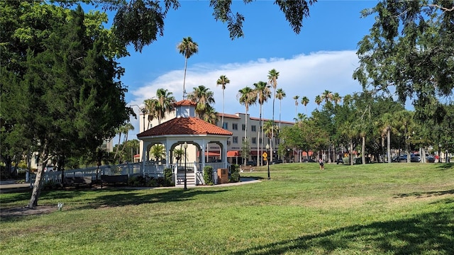 surrounding community with a gazebo and a yard