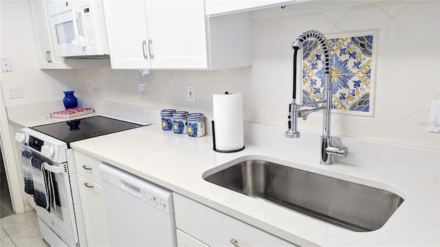 512 W Venice Ave Unit 102, Venice, FL 34285 - kitchen featuring white appliances, a sink, white cabinetry, backsplash, and light stone countertops