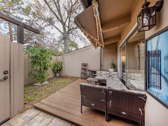 wooden terrace with a fenced backyard