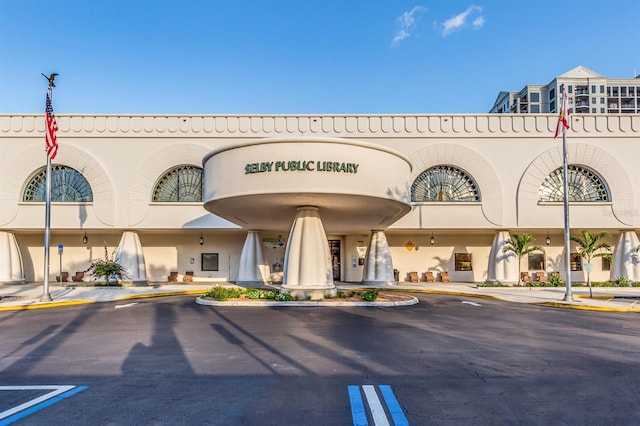 view of building exterior with uncovered parking