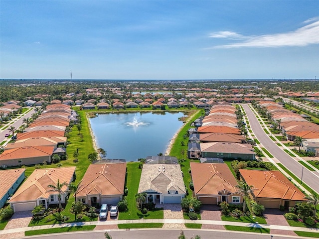 birds eye view of property featuring a residential view and a water view