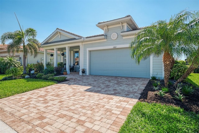 view of front of property featuring a garage and decorative driveway