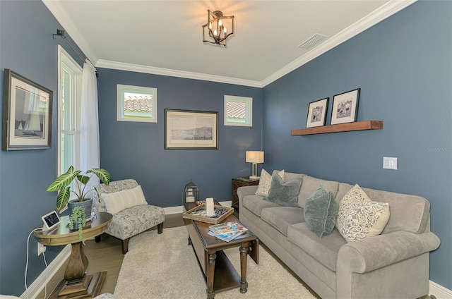 living area featuring baseboards, visible vents, and crown molding
