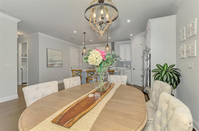 dining room featuring recessed lighting, dark wood-style flooring, ornamental molding, baseboards, and a notable chandelier