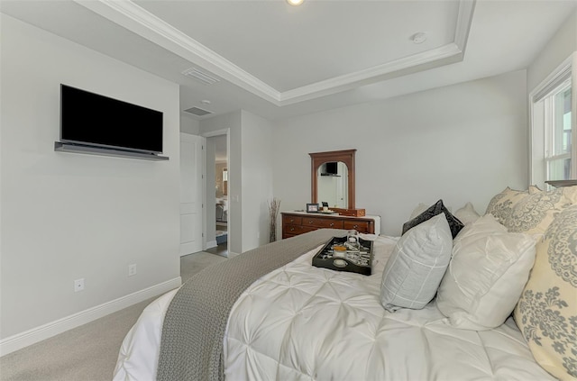 bedroom with baseboards, carpet floors, a tray ceiling, and visible vents