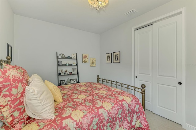 bedroom with light carpet, visible vents, and a closet