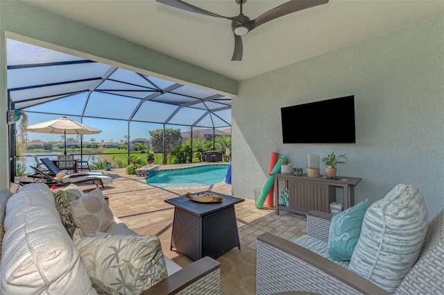 view of patio with outdoor lounge area, glass enclosure, an outdoor pool, and ceiling fan