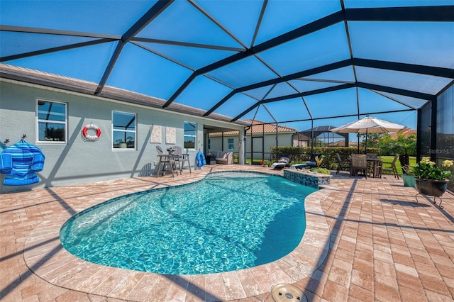 pool with glass enclosure and a patio area