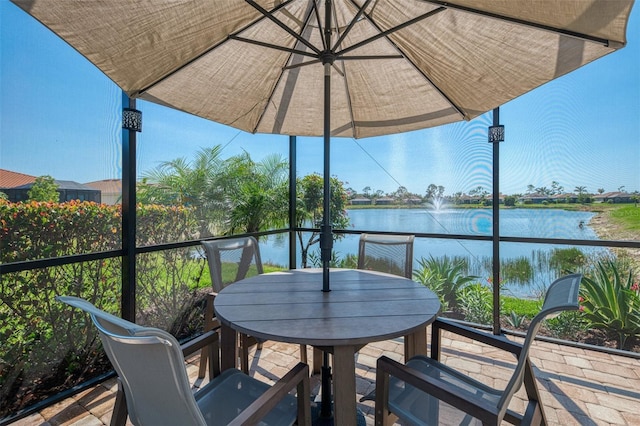 exterior space featuring a water view and outdoor dining area