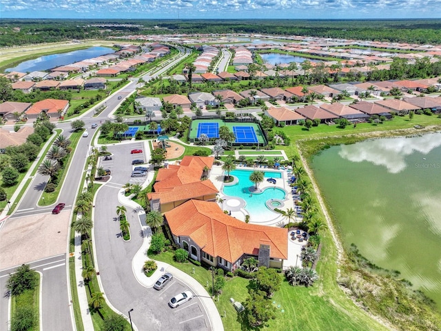 drone / aerial view with a residential view and a water view