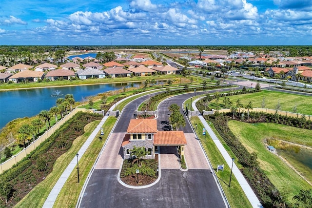 drone / aerial view featuring a residential view and a water view