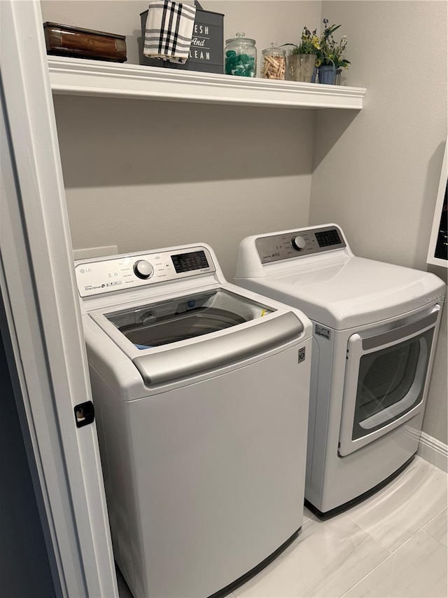 clothes washing area with laundry area and washer and clothes dryer