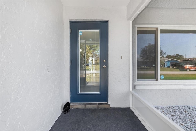 2102 Alaric St, Port Charlotte, FL 33952 - doorway to property featuring stucco siding