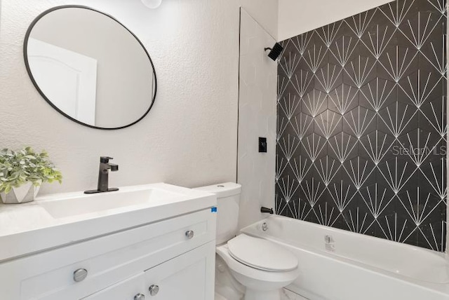 full bathroom featuring tub / shower combination, a textured wall, toilet, and vanity