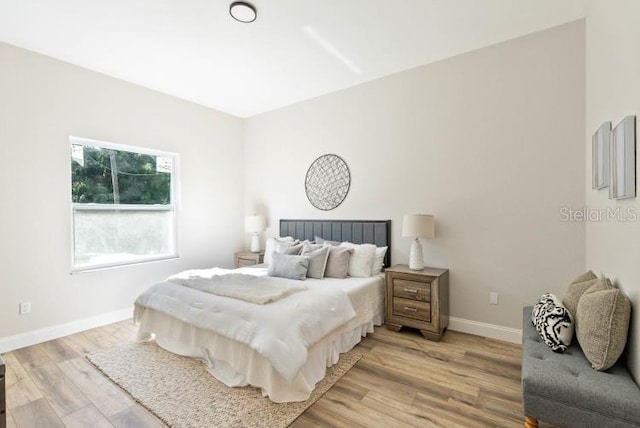 bedroom featuring baseboards and light wood-type flooring