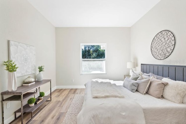 bedroom featuring baseboards and light wood-type flooring