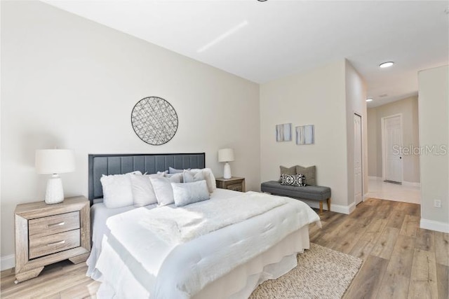 bedroom featuring baseboards and light wood-type flooring